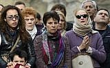 People observe a minute of silence on November 16, 2015 in front of the Le Carillon cafe in Paris, to pay tribute to victims of the attacks claimed by Islamic State which killed at least 129 people and left more than 350 injured on November 13. (AFP Photo/Lionel Bonaventure)