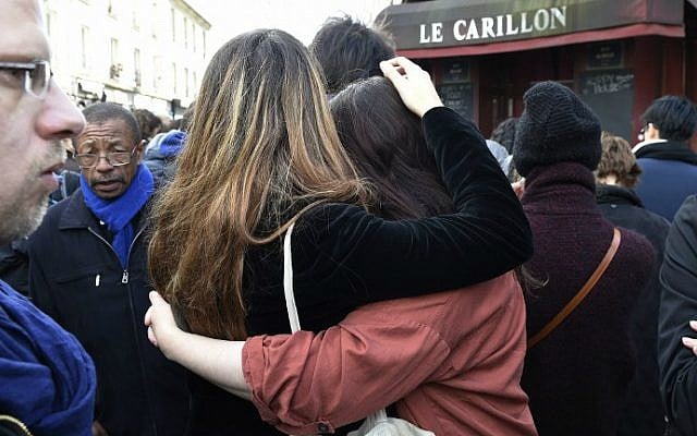 People react after observing a minute of silence on November 16, 2015 at the Le Carillon cafe at the corner of Rue Bichat and Alibert in the 10th arrondissement and "Le petit Cambodge" restaurant at the site of the attacks in Paris, to pay tribute to victims of the attacks claimed by Islamic State which killed at least 129 people and left more than 350 injured on November 13. (AFP Photo/Eric Feferberg) People react after observing a minute of silence on November 16, 2015 at the Le Carillon cafe at the corner of Rue Bichat and Alibert in the 10th arrondissement and "Le petit Cambodge" restaurant at the site of the attacks in Paris, to pay tribute to victims of the attacks claimed by Islamic State which killed at least 129 people and left more than 350 injured on November 13. (AFP Photo/Eric Feferberg)