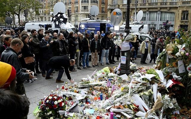 People gather to observe a minute of silence on November 16, 2015 near the Bataclan concert hall in Paris, to pay tribute to victims of the attacks claimed by Islamic State which killed at least 129 people and left more than 350 injured on November 13. (AFP Photo/Bertrand Guay) People gather to observe a minute of silence on November 16, 2015 near the Bataclan concert hall in Paris, to pay tribute to victims of the attacks claimed by Islamic State which killed at least 129 people and left more than 350 injured on November 13. (AFP Photo/Bertrand Guay)