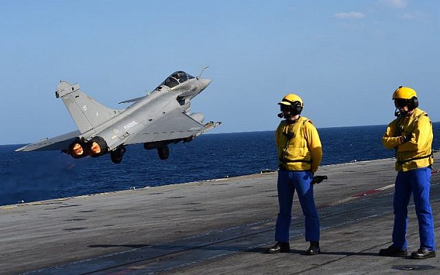 A French Rafale fighter aircraft takes off with bombs from the French aircraft carrier Charles de Gaulle, in the Mediterranean sea, as part of operation Chammal in Syria and Iraq against the Islamic State group, November 23, 2015. (AFP/ANNE-CHRISTINE POUJOULAT) A French Rafale fighter aircraft takes off with bombs from the French aircraft carrier Charles de Gaulle, in the Mediterranean sea, as part of operation Chammal in Syria and Iraq against the Islamic State group, November 23, 2015. (AFP/ANNE-CHRISTINE POUJOULAT)