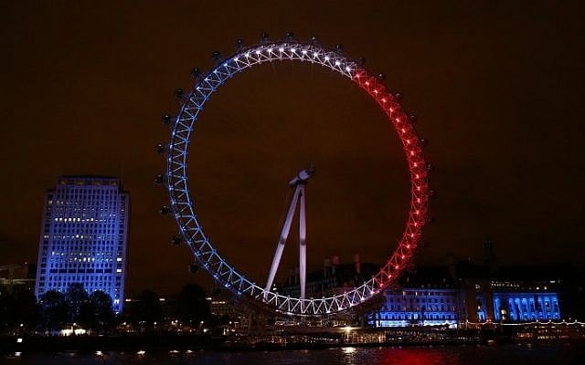 London landmark The London Eye is illuminated in blue, white and red lights, resembling the colors of the French national flag, in London on November 14, 2015 (Justin Tallis/AFP)