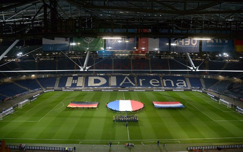German, French and Dutch flags are seen during a rehearsal prior to a friendly football match between Germany and the Netherlands in Barsinghausen, Germany on November 17, 2015. (AFP PHOTO/DPA/ PETER STEFFEN)