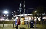 A football fan with a French flag stands outside a soccer stadium in Hanover, Germany after a game was called off for 'security reasons' in Hanover on November 17, 2015.  (AFP / DPA / OLE SPATA)