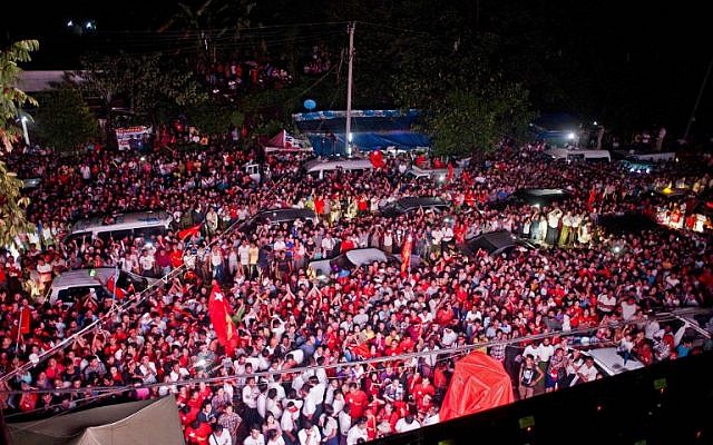 Supporters of Myanmar opposition leader Aung San Suu Kyi celebrate as they look at the official election results outside the National League of Democracy headquarters in Yangon on November 9, 2015. (Photo by AFP Photo / Ye Aung Thu)