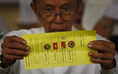 In this photo taken on November 8, 2015, a poll official displays a ballot marked for the candidate of Myanmar opposition leader Aung San Suu Kyi's National League for Democracy during poll tabulation in Yangon. (Photo by AFP Photo / Romeo Gacad) In this photo taken on November 8, 2015, a poll official displays a ballot marked for the candidate of Myanmar opposition leader Aung San Suu Kyi's National League for Democracy during poll tabulation in Yangon. (Photo by AFP Photo / Romeo Gacad)