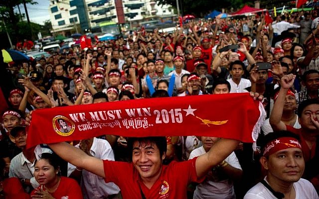 Supporters of Myanmar opposition leader Aung San Suu Kyi celebrate as they look at the official election results outside the National League of Democracy headquarters in Yangon on November 9, 2015. (Photo by AFP Photo / Ye Aung Thu)