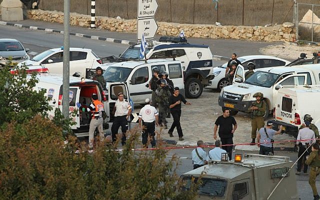 Israeli security forces and emergency personnel gather at the site of a reported car-ramming attack on Border Police at the Beit Einun junction, north of the West Bank city of Hebron, on November 1, 2015. (AFP/Hazem Bader) Israeli security forces and emergency personnel gather at the site of a reported car-ramming attack on Border Police at the Beit Einun junction, north of the West Bank city of Hebron, on November 1, 2015. (AFP/Hazem Bader)