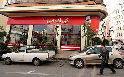 A man walks past the fried chicken shop "KFC Halal", using the brand name of US fast food giant KFC, after it was closed by Iranian police, on November 3, 2015, in the capital Tehran. (AFP PHOTO / STR)