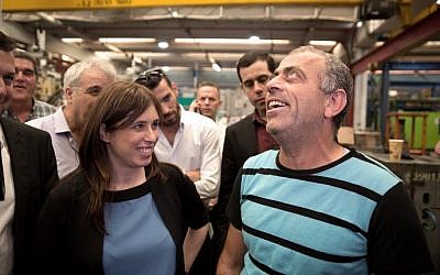 Deputy Foreign Minister Tzipi Hotovely (L) talks with a Palestinian worker on November 3, 2015 as she visits the Lipski plastic factory at the Barkan Industrial Park near the Israeli settlement of Ariel in the West Bank, after the European Union's (EU) decision to label goods made in Jewish settlements. (Menahem Kahana/AFP)