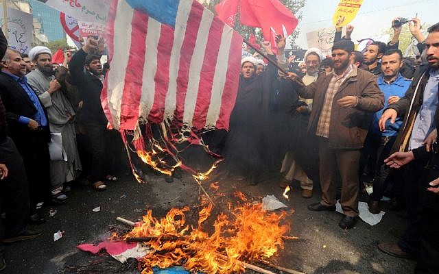 Iranians burn a US  flag outside the former US embassy in the Iranian capital Tehran during a demonstration marking the anniversary of its storming by student protesters that triggered a hostage crisis in 1979, November 4, 2015. (Photo by AFP Photo / Atta Kenare)