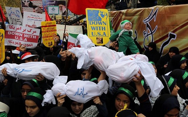 Iranian women and children carry  placards and dummies outside the former US embassy in the Iranian capital Tehran during a demonstration marking the anniversary of its storming by student protesters that triggered a hostage crisis in 1979, November 4, 2015. (Photo by AFP Photo / Atta Kenare)