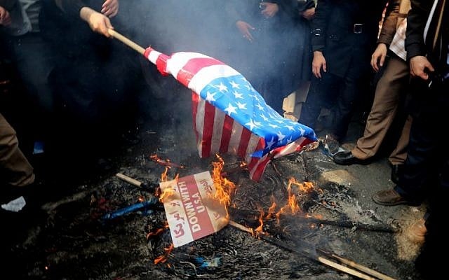 Iranians burn a US flag outside the former US embassy in the Iranian capital Tehran during a demonstration marking the anniversary of its storming by student protesters that triggered a hostage crisis in 1979, November 4, 2015. (Photo by AFP Photo / Atta Kenare)