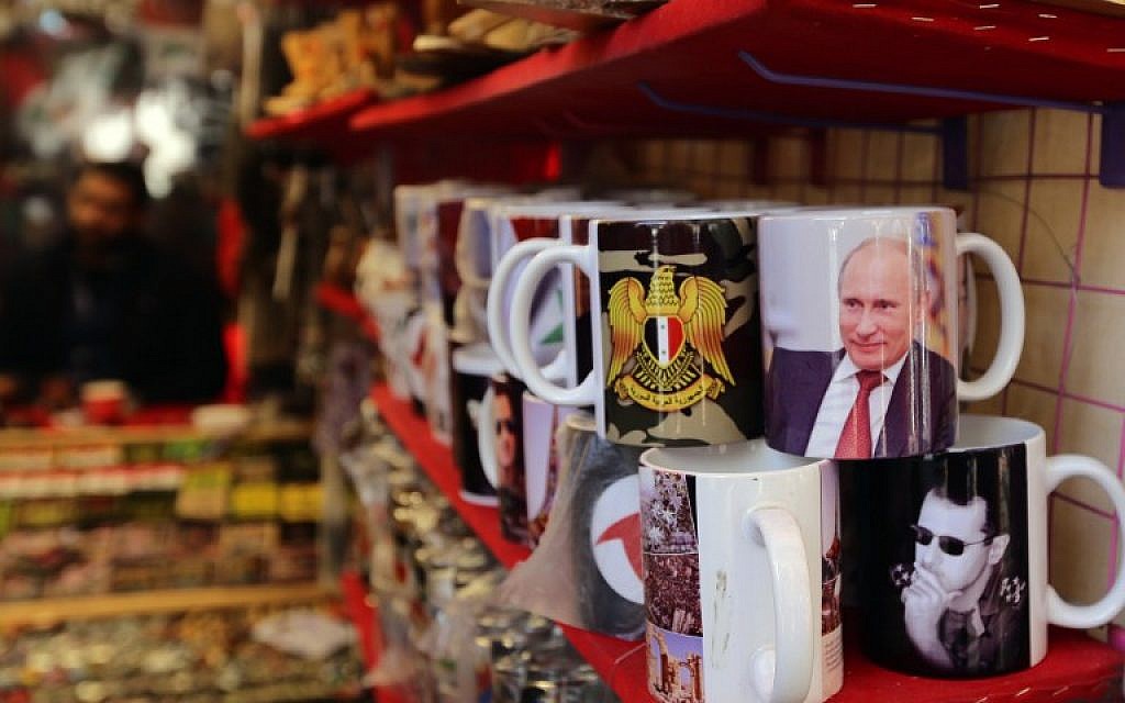Mugs bearing portraits of Syrian President Bashar Assad and Russian President Vladimir Putin are seen on display at a shop in Hamidiya market in the Syrian capital, Damascus, on November 10, 2015 (AFP PHOTO/LOUAI BESHARA)