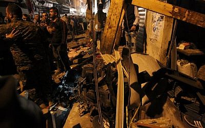 Emergency personnel gather at the site of a twin suicide bombing in the southern suburbs of Beirut on November 12, 2015. (AFP PHOTO/ANWAR AMRO)