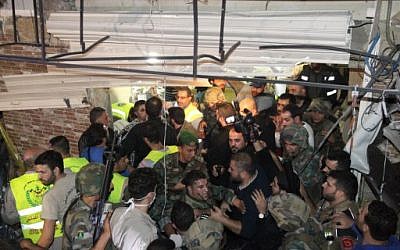 Emergency personnel and army soldiers gather at the site of a twin suicide bombing in Burj al-Barajneh, in the southern suburbs of the Lebanese capital of Beirut, November 12, 2015. (AFP/Anwar Amro)