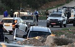Israeli soldiers and police inspect a car following a deadly attack near the settlement of Otniel, south of the West Bank city of Hebron, on November 13, 2015. (AFP/Hazem Bader)
