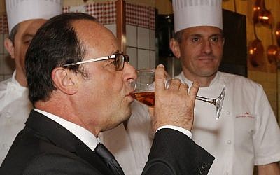 French President Francois Hollande drinks a glass of cider during a visit to Le Mont-Saint-Michel, on October 31, 2015. (AFP/Pool/Stephane Mahe)