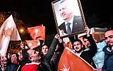 Supporters of Turkey's Justice and Development Party (AKP) hold up a portrait of Turkish President Recep Tayyip Erdogan as they celebrate in Istanbul after the first results in the country's general election on November 1, 2015. (AFP/Ozan Kose)