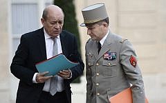 French Chief of the Defense Staff General Pierre de Villiers (R) and French Defense minister Jean-Yves Le Drian arrive at the Elysee Palace in Paris for a security meeting on November 14, 2015, following a series of coordinated attacks in and throughout Paris which left more than 120 people dead. (AFP PHOTO / STEPHANE DE SAKUTIN)