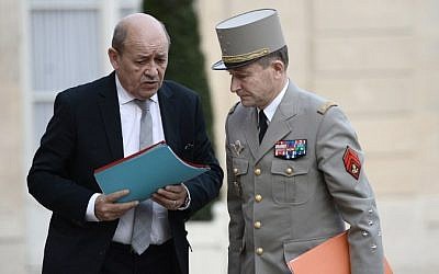 French Chief of the Defense Staff General Pierre de Villiers (R) and French Defense minister Jean-Yves Le Drian arrive at the Elysee Palace in Paris for a security meeting on November 14, 2015, following a series of coordinated attacks in and throughout Paris which left more than 120 people dead. (AFP PHOTO / STEPHANE DE SAKUTIN)