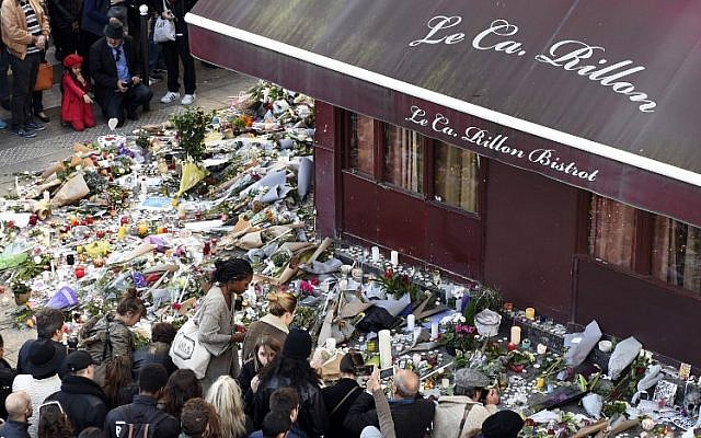 People gather at a makeshift memorial in front of Le Carillon restaurant in the 10th district of Paris, on November 15, 2015. (AFP/Alain Jocard)