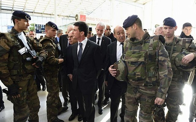 French Prime minister Manuel Valls, center, arrives with French Defense minister Jean-Yves Le Drian and other officials at the Gare du Nord railway station in Paris on November 15, 2015, to speak with SNCF staff about security measures following a series of coordinated attacks in and around Paris on November 13. (AFP/ERIC FEFERBERG) French Prime minister Manuel Valls, center, arrives with French Defense minister Jean-Yves Le Drian and other officials at the Gare du Nord railway station in Paris on November 15, 2015, to speak with SNCF staff about security measures following a series of coordinated attacks in and around Paris on November 13. (AFP/ERIC FEFERBERG)