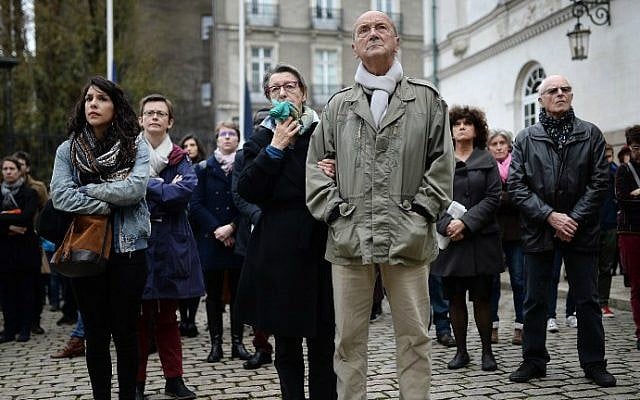 People observe a minute of silence in tribute to the victims of the attacks in Paris on November 16, 2015 at the city hall of Nantes, western France. (AFP Photo/Jean-Sebastien Evrard) People observe a minute of silence in tribute to the victims of the attacks in Paris on November 16, 2015 at the city hall of Nantes, western France. (AFP Photo/Jean-Sebastien Evrard)
