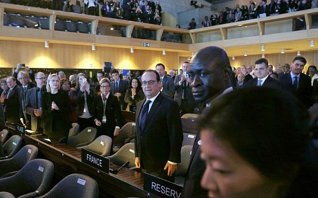 French President Francois Hollande (C) arrives with a standing ovation to the 70th General Conference of the United Nations Educational, Scientific and Cultural Organization (UNESCO) at the UNESCO headquarters in Paris, on November 17, 2015. (Yoan Valat/AFP/POOL) French President Francois Hollande (C) arrives with a standing ovation to the 70th General Conference of the United Nations Educational, Scientific and Cultural Organization (UNESCO) at the UNESCO headquarters in Paris, on November 17, 2015. (Yoan Valat/AFP/POOL)