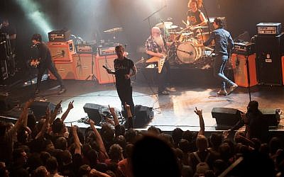 File: American rock group Eagles of Death Metal performing on stage at the Bataclan concert hall in Paris, a few moments before men armed with assault rifles stormed into the venue killing 89 people, November 13, 2015. (AFP Photo/Marion Ruszniewski)