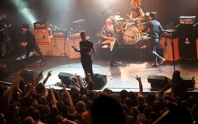 File: American rock group Eagles of Death Metal performing on stage at the Bataclan concert hall in Paris, a few moments before men armed with assault rifles stormed into the venue killing 89 people, November 13, 2015. (AFP Photo/Marion Ruszniewski)