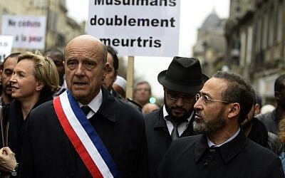 French imam of Bordeaux's mosque Tareq Oubrou and Mayor of Bordeaux Alain Juppe attend a gathering in Bordeaux on November 20, 2015 as part of a public tribute to the victims of the November 13 Paris attacks. Oubrou has called muslims to "change the way of thinking" and "to disconnect from a besieged culture", considering mosques as "the next step" of terrorism. (Photo by AFP Photo / Jean-Pierre Muller)