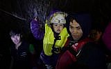 Migrants and refugees arrive on the Greek island of Lesbos after crossing the Aegean Sea from Turkey on November 20, 2015.(AFP PHOTO/BULENT KILIC)