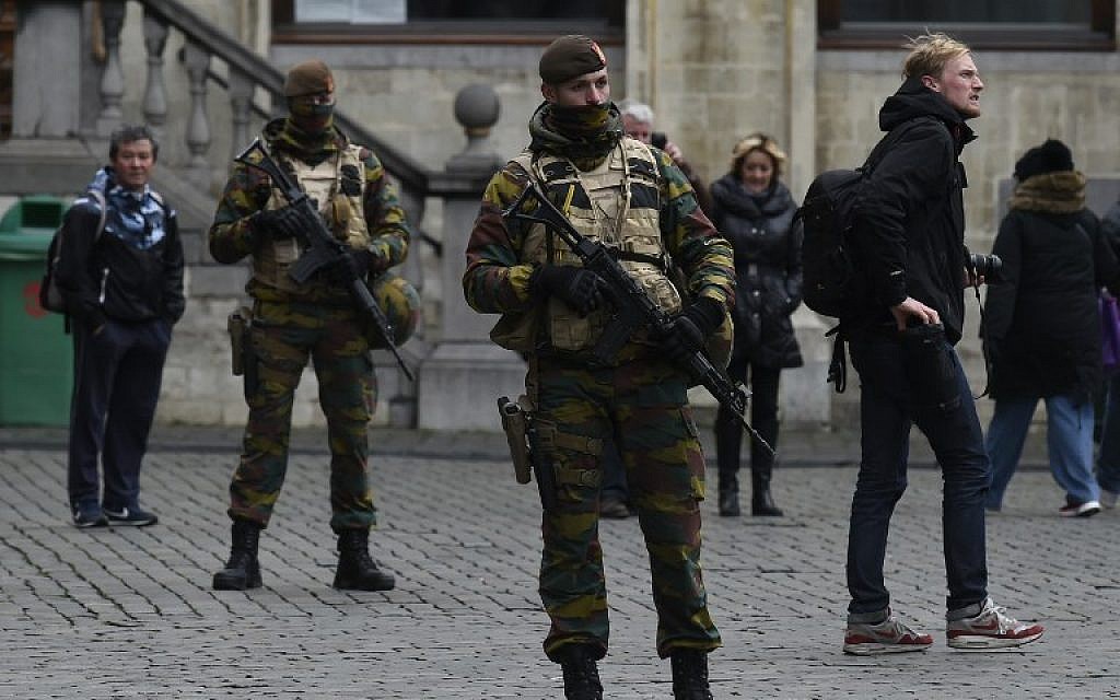 Belgian soldiers stand at the Grand Place in Brussels on November 22, 2015. The Belgian capital was locked down for a second day on November 22 with police and troops on the streets as the authorities hunted for several suspects linked to the Paris attacks. (Photo by AFP Photo/John Thys) Belgian soldiers stand at the Grand Place in Brussels on November 22, 2015. The Belgian capital was locked down for a second day on November 22 with police and troops on the streets as the authorities hunted for several suspects linked to the Paris attacks. (Photo by AFP Photo/John Thys)