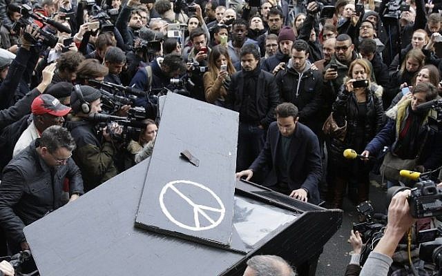 A man plays piano near the cordened off area around the Bataclan theatre in the 11th district of Paris on November 14, 2015, after a series of attacks on the city resulting in the deaths of at least 120 individuals. (AFP PHOTO / KENZO TRIBOUILLARD) A man plays piano near the cordened off area around the Bataclan theatre in the 11th district of Paris on November 14, 2015, after a series of attacks on the city resulting in the deaths of at least 120 individuals. (AFP PHOTO / KENZO TRIBOUILLARD)