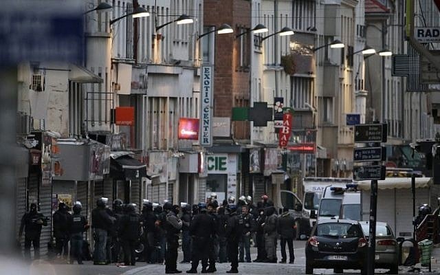Policemen are gathered in the northern Paris suburb of Saint-Denis city center, on November 18, 2015, as French Police special forces raid an apartment, hunting those behind the attacks that claimed 129 lives in the French capital five days ago. (AFP PHOTO / KENZO TRIBOUILLARD) Policemen are gathered in the northern Paris suburb of Saint-Denis city center, on November 18, 2015, as French Police special forces raid an apartment, hunting those behind the attacks that claimed 129 lives in the French capital five days ago. (AFP PHOTO / KENZO TRIBOUILLARD)