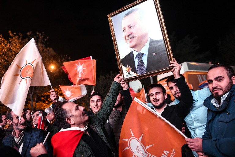 Supporters of Turkey's Justice and Development Party (AKP) hold up a portrait of Turkish President Recep Tayyip Erdogan as they celebrate in Istanbul after the first results in the country's general election on November 1, 2015. (Photo by AFP Photo / Ozan Kose) Supporters of Turkey's Justice and Development Party (AKP) hold up a portrait of Turkish President Recep Tayyip Erdogan as they celebrate in Istanbul after the first results in the country's general election on November 1, 2015. (Photo by AFP Photo / Ozan Kose)