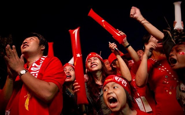 Supporters of Myanmar opposition leader Aung San Suu Kyi celebrate as they look at the official election results outside the National League of Democracy headquarters in Yangon on November 9, 2015. (Photo by AFP Photo / Ye Aung Thu)