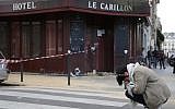 A woman mourns outside of the Carillon bar in the 10th district of Paris on November 14, 2015, following a series of attacks in and around the city, leaving at least 120 people killed. AFP PHOTO / KENZO TRIBOUILLARD