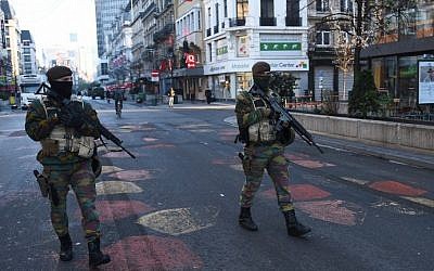 Belgian troops patrol a street in Brussels on November 23, 2015, as the Belgian capital remains on the highest possible alert level. (AFP/Emmanuel Dunand)