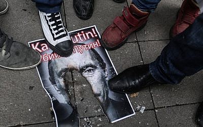 Turkish protesters walk over a burnt poster depicting Russian President Vladimir Putin and reading 'Putin, killer!' during an anti-Russia demonstration in Istanbul, November 27, 2015. (AFP/Cagdas Erdogan) Turkish protesters walk over a burnt poster depicting Russian President Vladimir Putin and reading 'Putin, killer!' during an anti-Russia demonstration in Istanbul, November 27, 2015. (AFP/Cagdas Erdogan)