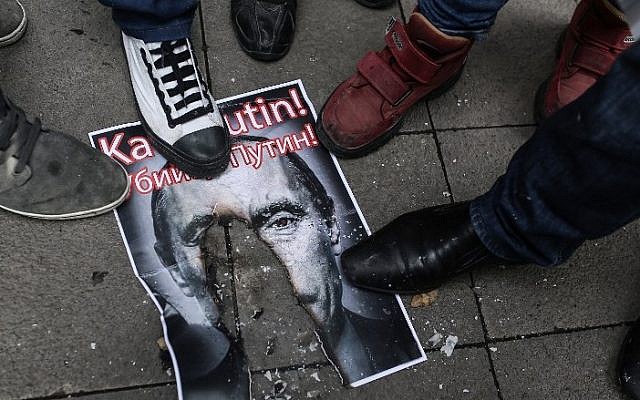 Turkish protesters walk over a burnt poster depicting Russian President Vladimir Putin and reading 'Putin, killer!' during an anti-Russia demonstration in Istanbul, November 27, 2015. (AFP/Cagdas Erdogan) Turkish protesters walk over a burnt poster depicting Russian President Vladimir Putin and reading 'Putin, killer!' during an anti-Russia demonstration in Istanbul, November 27, 2015. (AFP/Cagdas Erdogan)
