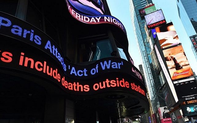 The ABC News Tickertape flashes the headline "Act of War" November 14, 2015 in Times Square in New York City (Timothy A. Clary/AFP)