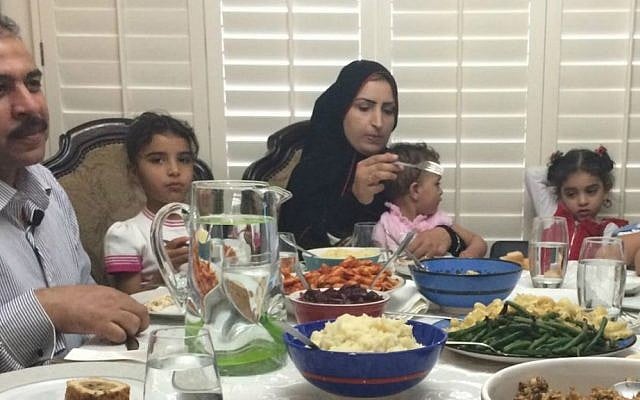 Syrian refugee family newly arrived to Phoenix, Arizona enjoy their first American Thanksgiving dinner at the home of human rights activist Rabbi Shmuly Yanklowitz, November, 26, 2015. (Courtesy)