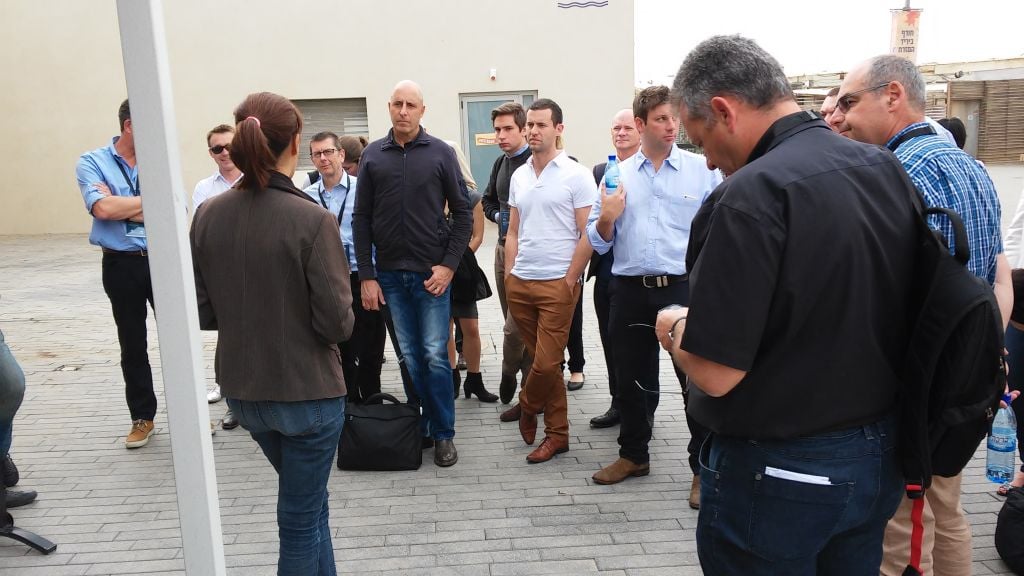 Members of the delegation listen to a speaker at Tel Aviv's port (Simona Weinglass/Times of Israel)