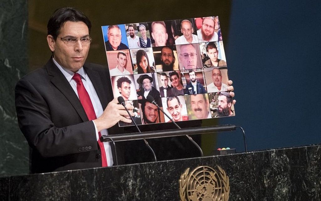 Israeli Ambassador to the UN, Danny Danon, holds up a collage of photos of Israeli terror victims killed in the ongoing surge of violence since mid-September, on November 23, 2015. (UN photo/ Cia Pak) Israeli Ambassador to the UN, Danny Danon, holds up a collage of photos of Israeli terror victims killed in the ongoing surge of violence since mid-September, on November 23, 2015. (UN photo/ Cia Pak)