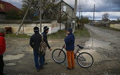 In this photo taken Thursday, Nov. 12, 2015 children play in a street in the village of Komsomolskoye, Dagestan, Russia. An epidemic of recruitment for the Islamic State group has swept through the predominantly Muslim Dagestan where young men and women are leaving for Syria, pursuing a religious ideal or trying to escape police profiling. (Sergei Grits/AP)