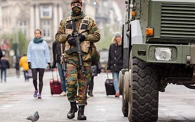 A Belgian Army soldier patrols on a main boulevard in Brussels, Sunday, Nov. 22, 2015. (AP Photo/Geert Vanden Wijngaert)