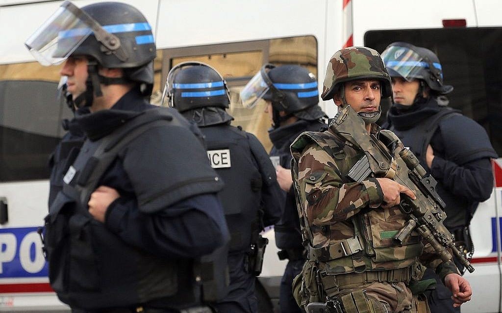Police forces and soldiers patrol in Saint-Denis, a northern suburb of Paris, Wednesday, November 18, 2015.  (AP/Christophe Ena)