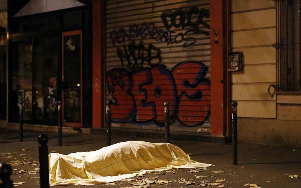 A victim under a blanket outside the Bataclan theater in Paris, Friday November 13, 2015. (AP Photo/Jerome Delay) A victim under a blanket outside the Bataclan theater in Paris, Friday November 13, 2015. (AP Photo/Jerome Delay)