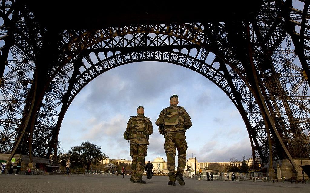 French soldiers patrol at the Eiffel Tower which remained closed on the first of three days of national mourning in Paris, Sunday, Nov. 15, 2015. (AP/Peter Dejong)